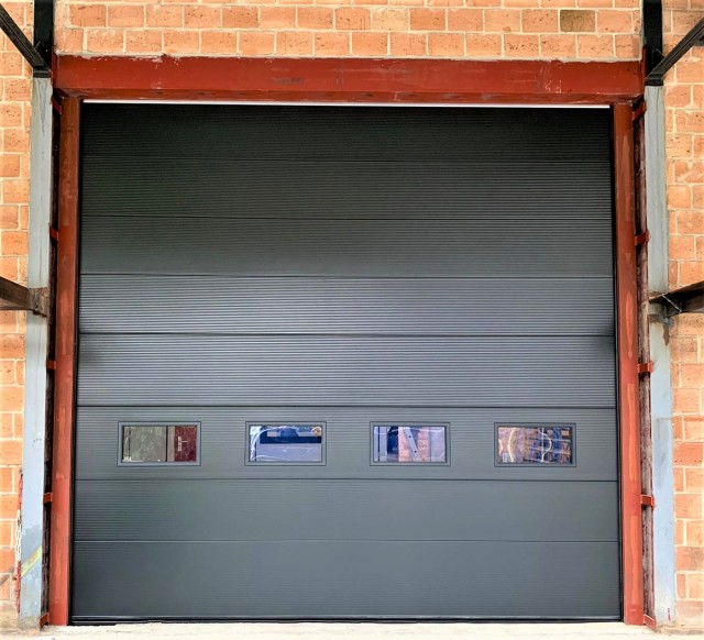 Industrial sectional garage door with Microline panels and 4 windows