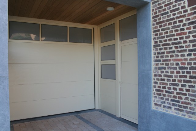 Matching side door next to sectional garage door with sections in full vision 